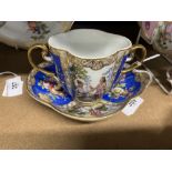 Helena Wolfson: two handled quatrefoil shape decorated cup and saucer, blue floral panels, alternate