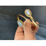 Jewellery: Opal and diamond bangle, 14K tested with twin opal and 32 small diamond terminals. 11g