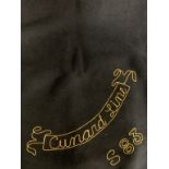 CUNARD: Red and dark blue steamer blanket with embroidered Cunard Line and number.