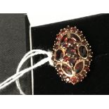 The Lady Lowry Jewellery Collection: Art deco dress ring. Garnet oval shield shape set on silver