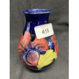 Moorcroft: Blue ground vase with stylised floral decoration. 5½ins.