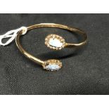 Jewellery: Opal and diamond bangle, 14K tested with twin opal Doublets and 32 small diamond