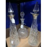 Glassware: 20th cent. Decanters, two of tapered design with hallmarked silver collars and one of