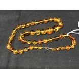 Jewellery: Clear graduated amber 48 bead necklace with inclusions.