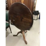 19th cent. Mahogany tilt top table on three splayed supports. The top is cut from a single plank.