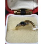 Jewellery: Yellow metal ring crossover channel set with six 1.7mm x 1.5mm baguette cut diamonds,