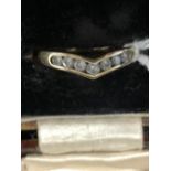 Hallmarked Gold: 9ct Wishbone ring set with seven cubic zirconia hallmarked London. 1.7g.