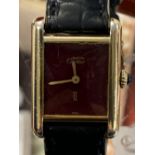 Watches: Silver gilt Cartier, burgundy strap watch with papers, c1980. Boxed.