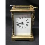 Clocks: Late 19th/early 20th cent. Brass carriage clock. White enamel face with Roman numerals,