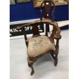 Early Georgian walnut high back corner chair, carved 'acanthus' shell decoration above a club