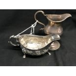 Hallmarked Silver: Embossed creamer, shell pattern & hoof feet, initialed E.W London marks 1743.