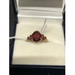 Hallmarked Gold: 9ct ring set with seven garnets hallmarked London 1979. Weight 2.4g.