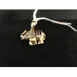 Hallmarked Gold: Yellow metal pendant in the form of an elephant set with thirteen rubies, estimated