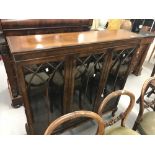 20th cent. Mahogany three door glazed bookcase, Gothic arch mouldings, on cabriole supports. 46½ins.