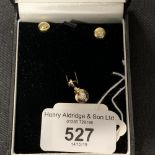 Hallmarked Gold: 18ct gold earrings and a 9ct gold pendant, each set with a single brilliant cut