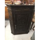 18th cent. Oak corner cupboard, ornately carved, with locking door, two serpentine shelves to the