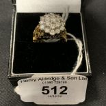 Diamond Jewellery: Yellow and white metal twenty one stone triple tier cluster consisting of