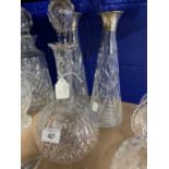 Glassware: 20th cent. Decanters, two of tapered design with hallmarked silver collars and one of