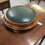 19th cent. Circular oak padded footstool on 4 bun feet. 13ins.