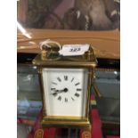 Clocks: Late 19th/early 20th cent. Brass carriage clock. White enamel face with Roman numerals,