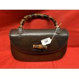 Fashion: Gucci brown leather bamboo handle handbag. Leather lined, zip compartment plus 2 more,