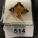 Hallmarked Gold : 18ct ring having a fancy cut citrine with a triangular cut amethyst either side.