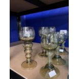 Glassware: Bohemian style amber goblets with decorated raspberry prunt stems x 6.
