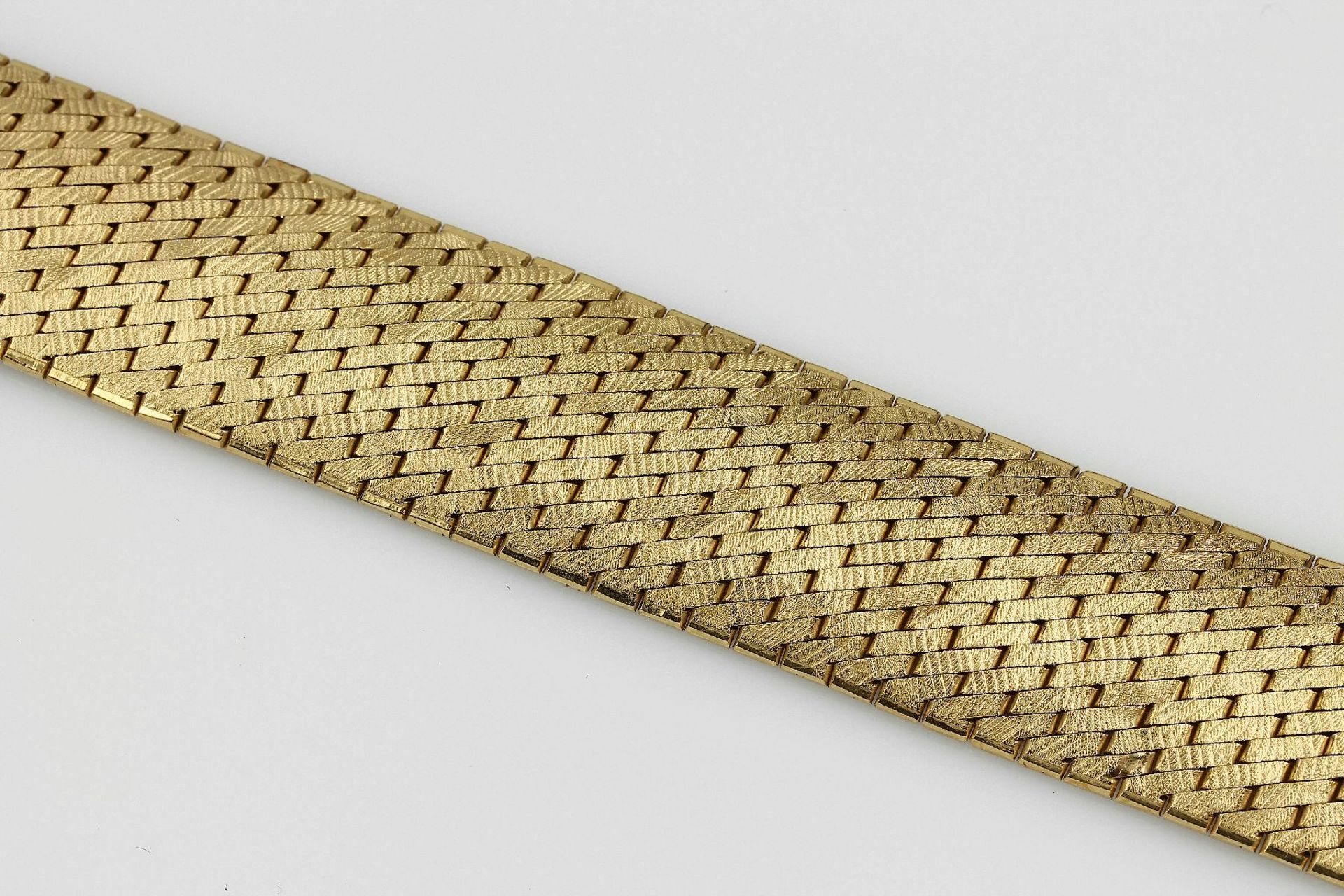 18 kt Gold Armband, GG 750/000, diagonale Backsteinoptik, Oberfläche z.T. grav., 1 Gliedl. besch.,