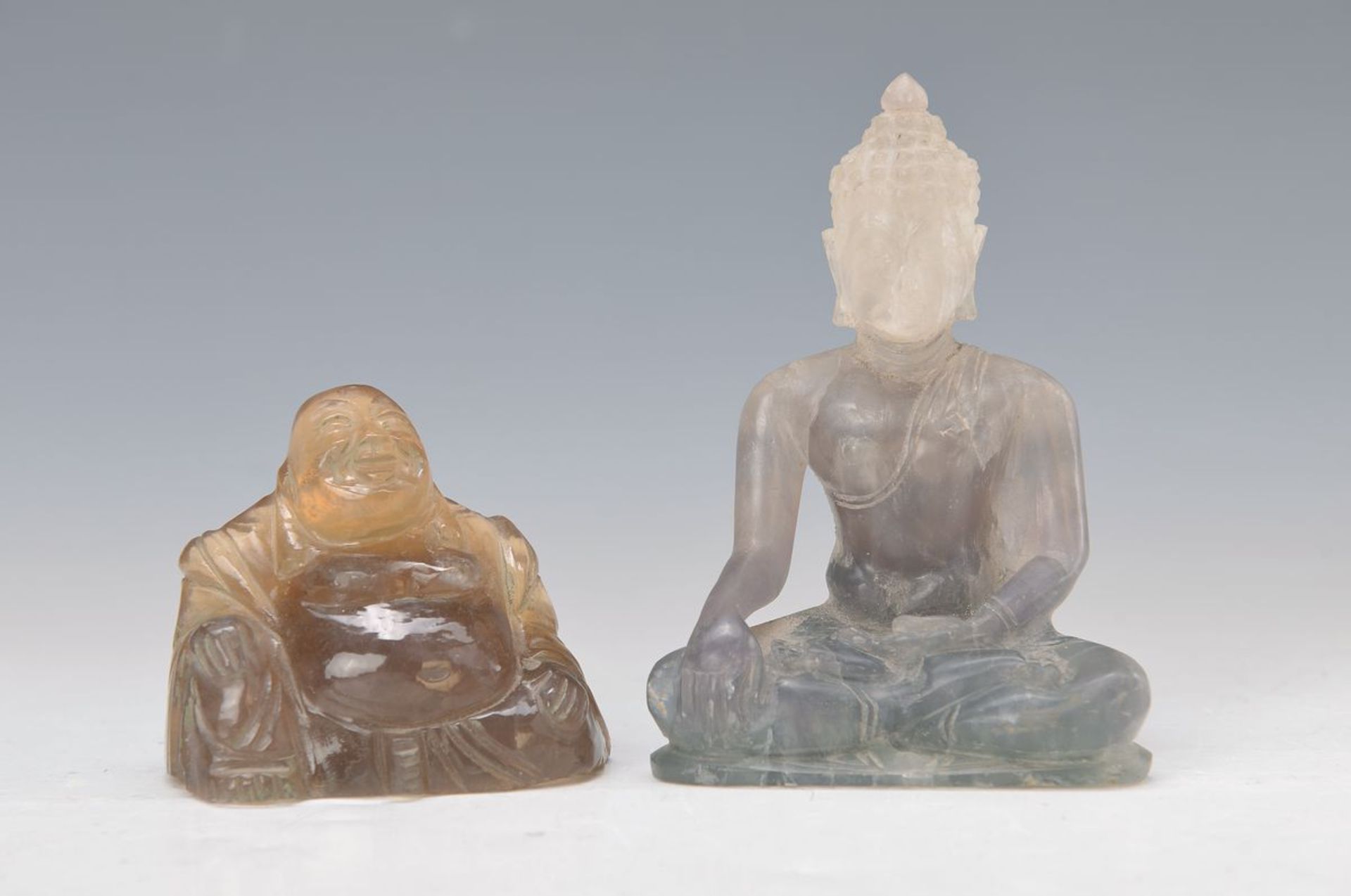 two Buddha sculptures, China, rock crystal andquartz crystal, H. approx. 7/11.5 cm