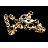 14kt geelgouden schakelarmband met fantasieschakels en twee witgouden tussenstukken - lengte 15,5 cm