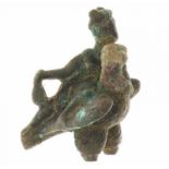 A decorative bronze statuette of a Roman eagle, head turned to right, with Hermes reclining,