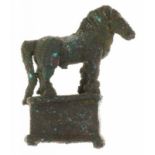 A nice old bronze statuette of a horse, standing on a basement (ca. 6 x 4,5 x 2 cm.)