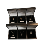 COLLECTION OF SIX ASSORTED PENDANTS ON CHAINS