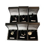 COLLECTION OF SIX ASSORTED PENDANTS ON CHAINS