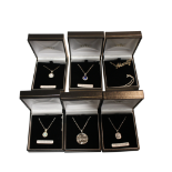 COLLECTION OF SIX ASSORTED PENDANTS ON CHAINS