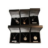 COLLECTION OF SIX ASSORTED PENDANTS ON CHAINS