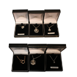 COLLECTION OF SIX ASSORTED PENDANTS ON CHAINS