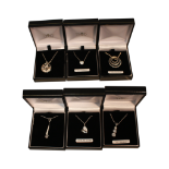 COLLECTION OF SIX ASSORTED PENDANTS ON CHAINS