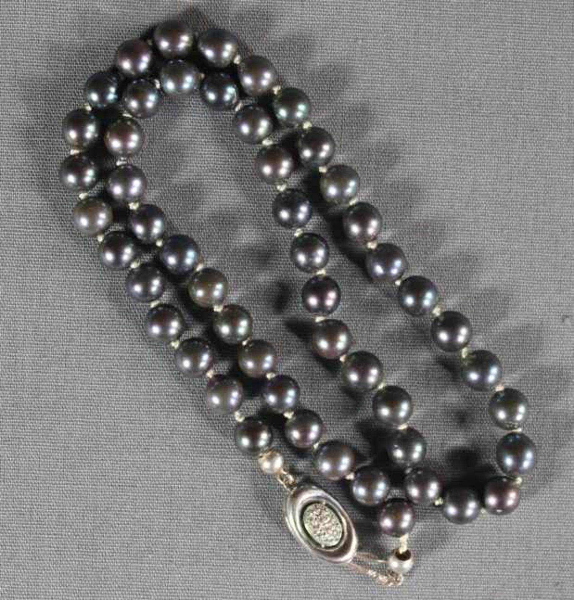 1 kurze graue Perlenkette, Perlen im schönen Lüster, ovaler Verschluß 14kt. (585/000) besetzt mit