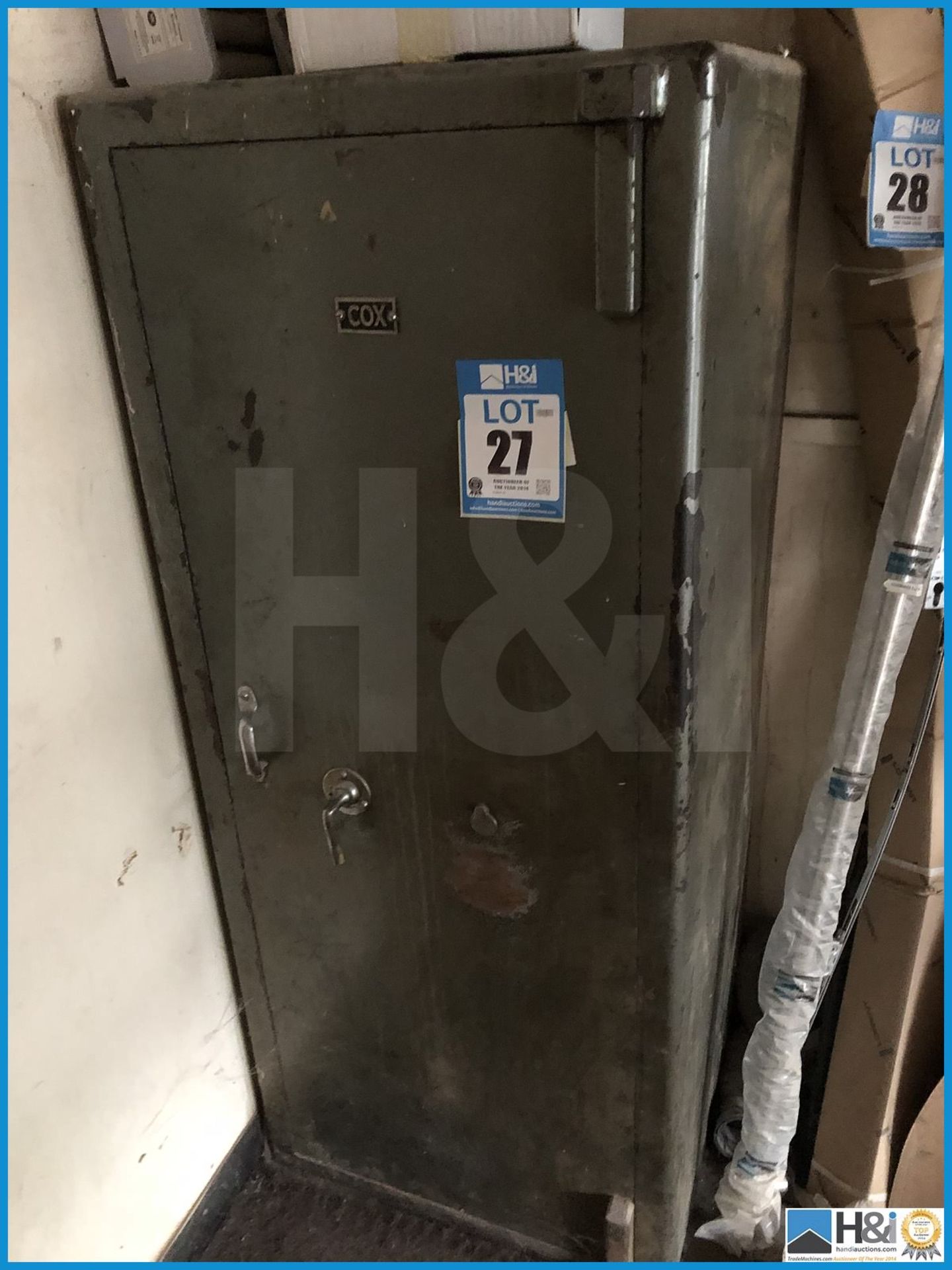Tall Cox metal safe with key. Excludes all contents. Lift out charge of GBP 20