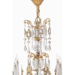 Lustre d'époque Napoléon III en bronze doré et cristal taillé à fût central balustre. dix-huit feux.