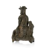 Guanyin assise sur un chien de Fô. sculpture en bronze. Chine. probablement dynastie Ming. h. 18 cm
