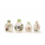 FOUR TRANSPARENT GLASS SNUFF BOTTLES