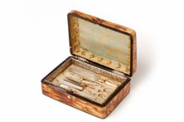 A 19TH CENTURY FRENCH TORTOISE SHELL BOX CONTAINING A MOTHER-OF-PEARL SEWING KIT