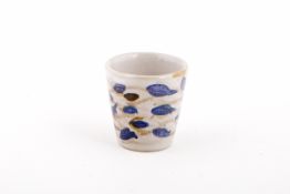 A SMALL POTTERY POT WITH BLUE FISHES