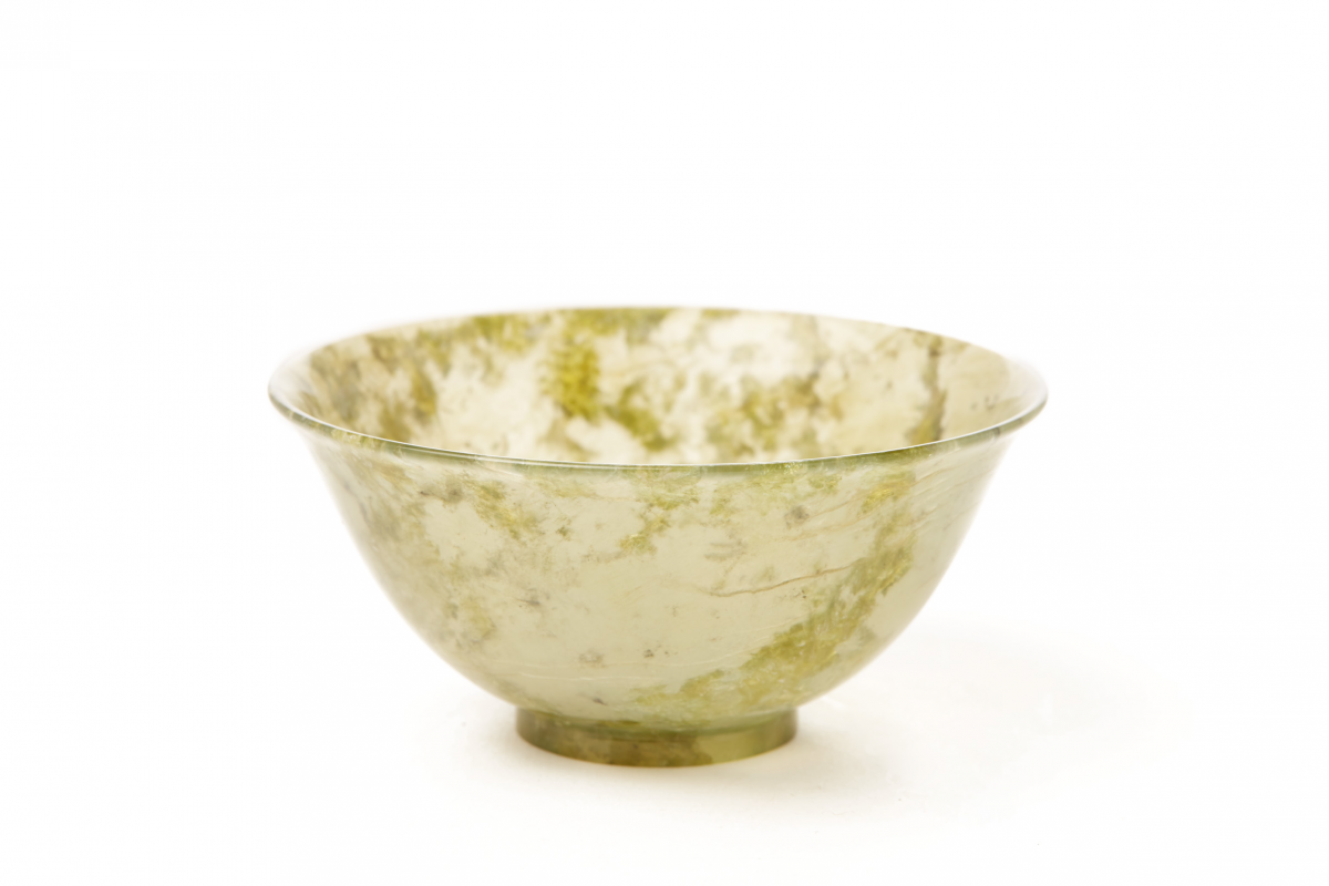 A CARVED TRANSLUCENT NEPHRITE/SERPENTINE STONE TEA BOWL