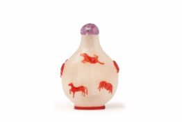 AN 'EIGHT HORSES' RED OVERLAY GLASS SNUFF BOTTLE