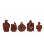 A COLLECTION OF FIVE CARVED CINNABAR SNUFF BOTTLES