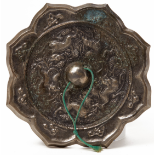 A SILVERY BRONZE 'ANIMAL AND GRAPEVINE' OCTAFOIL MIRROR