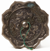 A SILVERY BRONZE 'ANIMAL AND GRAPEVINE' OCTAFOIL MIRROR